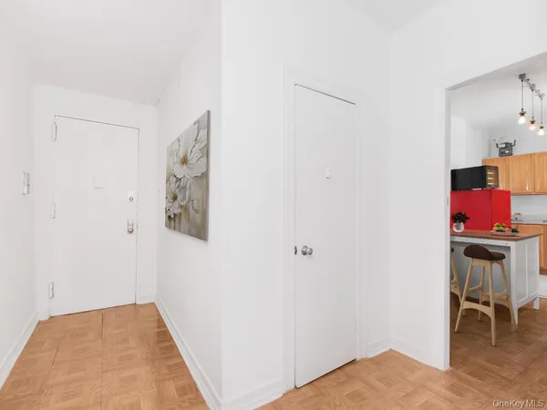 a view of hallway with furniture and floor to ceiling window