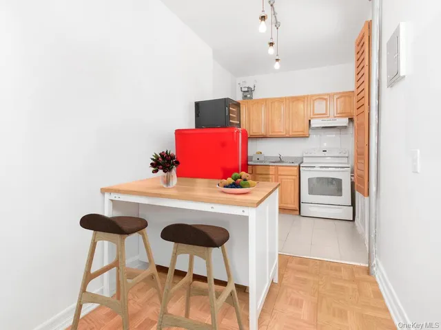 a kitchen with a stove a refrigerator and a sink