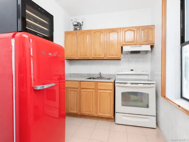 a kitchen with stainless steel appliances granite countertop a refrigerator and a stove top oven