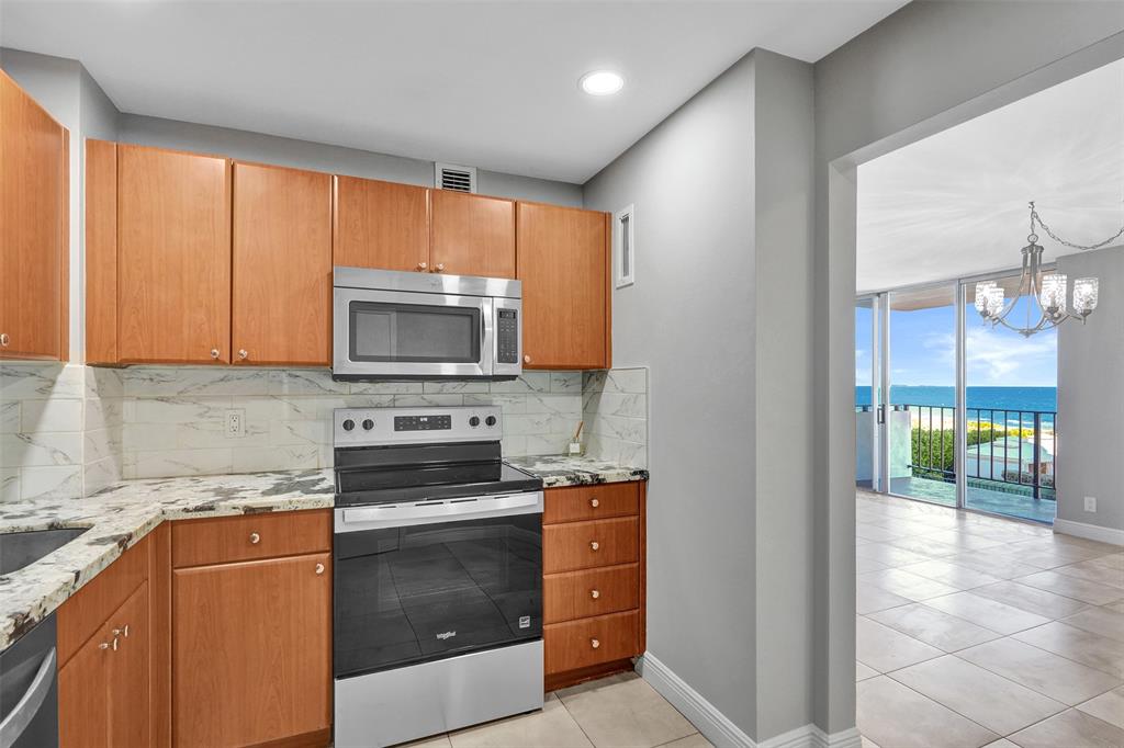 1900 South Ocean Boulevard, Unit 2F Lauderdale-by-the-Sea, FL 33062 - Photo 11 of 34 a kitchen with a stove microwave and sink