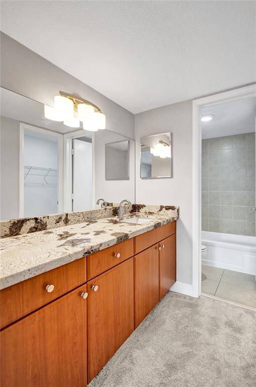 1900 South Ocean Boulevard, Unit 2F Lauderdale-by-the-Sea, FL 33062 - Photo 15 of 34 a bathroom with a granite countertop sink and a mirror