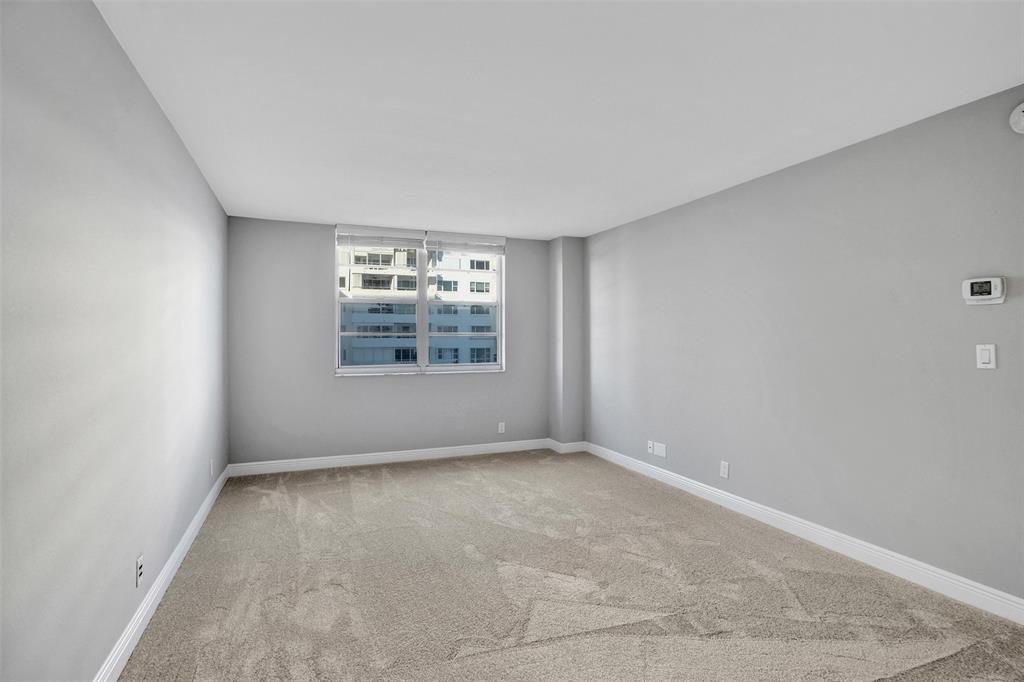 1900 South Ocean Boulevard, Unit 2F Lauderdale-by-the-Sea, FL 33062 - Photo 18 of 34 an empty room with windows