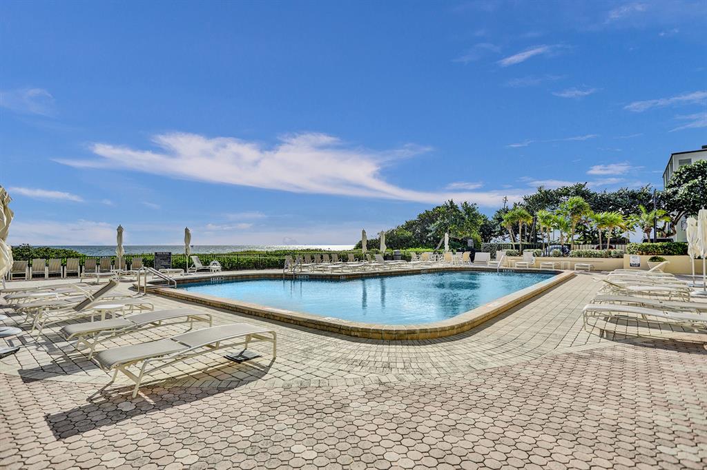1900 South Ocean Boulevard, Unit 2F Lauderdale-by-the-Sea, FL 33062 - Photo 20 of 34 a view of a swimming pool and a yard