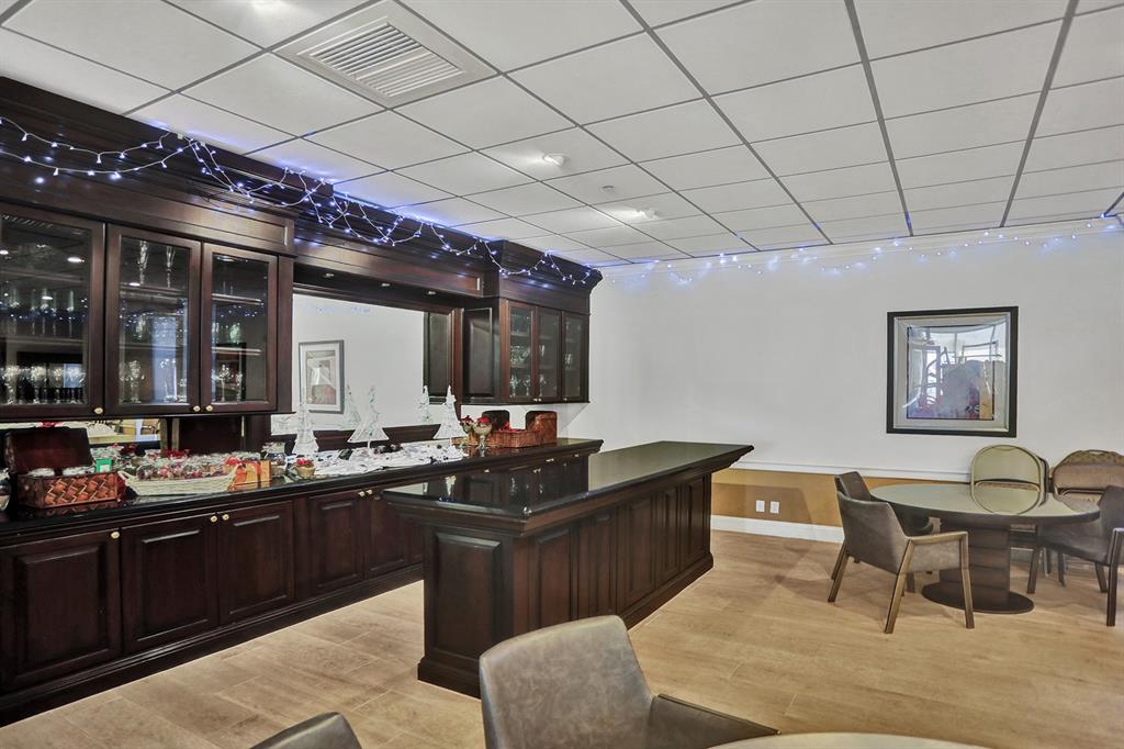 1900 South Ocean Boulevard, Unit 2F Lauderdale-by-the-Sea, FL 33062 - Photo 22 of 34 a kitchen with granite countertop lots of counter top space and dining table