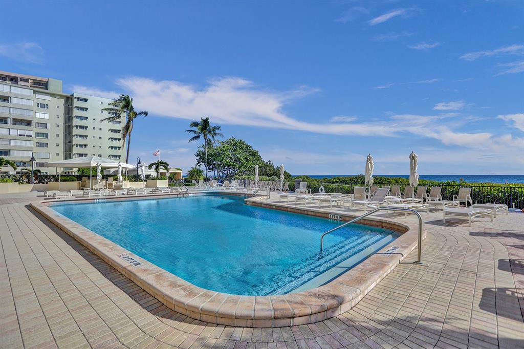 1900 South Ocean Boulevard, Unit 2F Lauderdale-by-the-Sea, FL 33062 - Photo 23 of 34 a view of a swimming pool with a lounge chair
