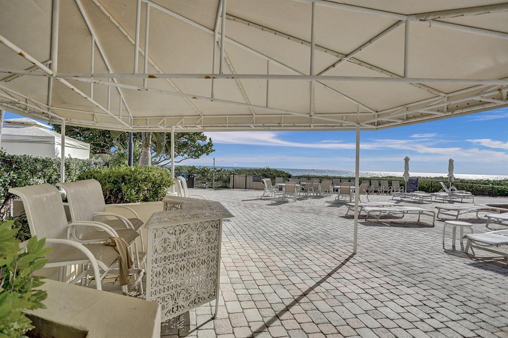 1900 South Ocean Boulevard, Unit 2F Lauderdale-by-the-Sea, FL 33062 - Photo 24 of 34 a view of a terrace with furniture and stove