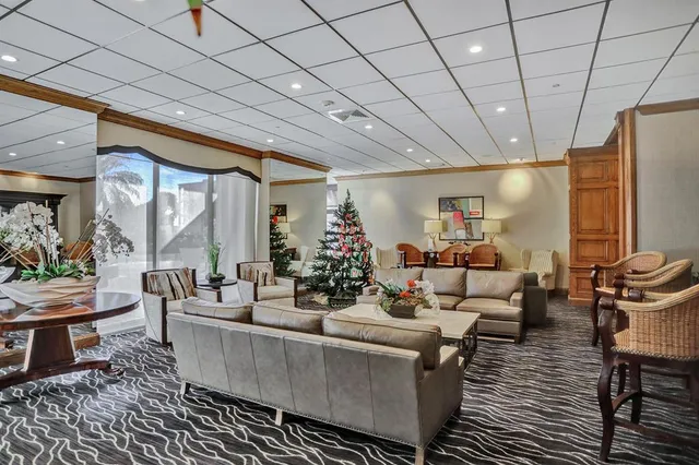 a room with pool table and windows