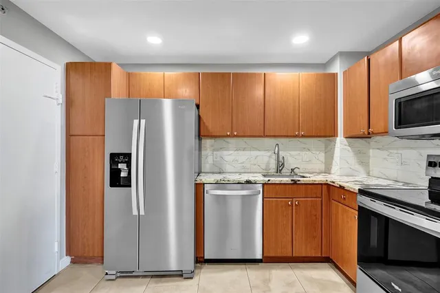 a kitchen with a stove microwave and sink