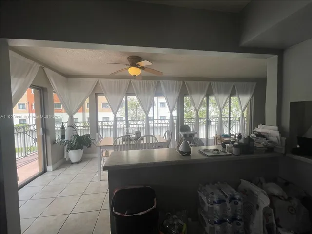 a room with gym equipment and large windows