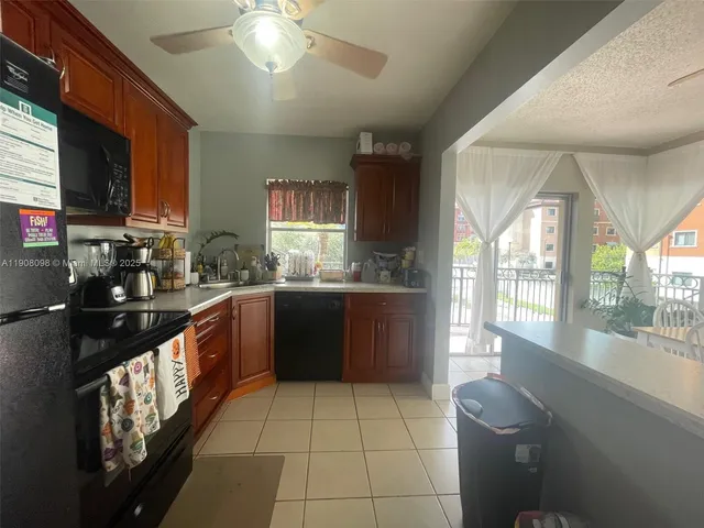a large kitchen with stainless steel appliances granite countertop a sink and a stove