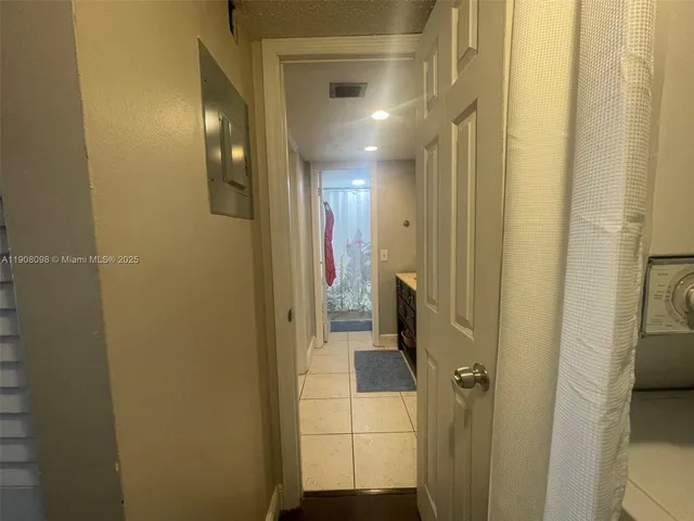 a view of a hallway with a bathroom