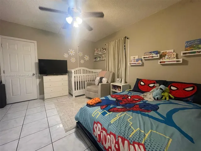 a bedroom with a bed and a tv