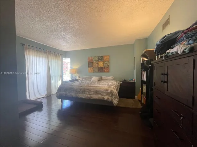 a bedroom with a bed toilet and window