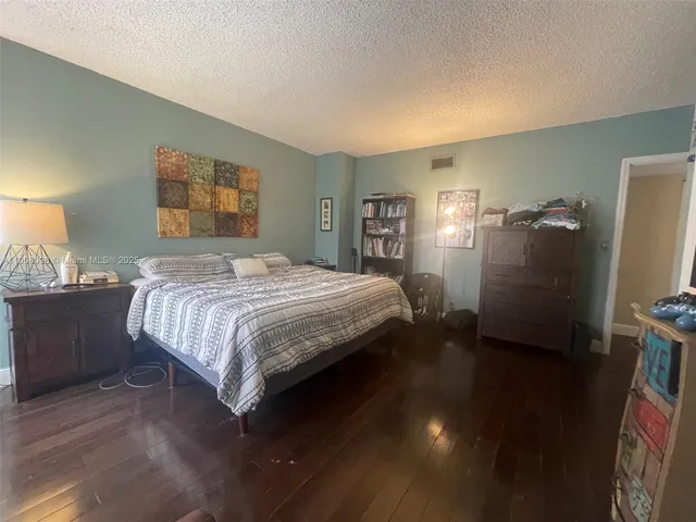 a bedroom with a bed and a night stand