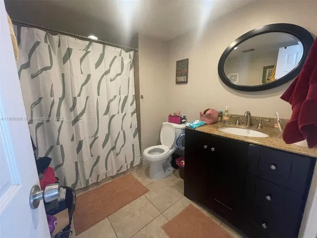 a bathroom with a sink vanity mirror and toilet