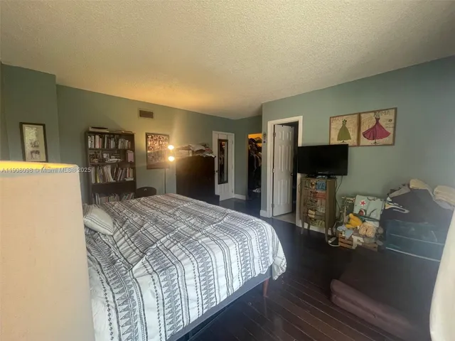 a bed room with a bed and a television