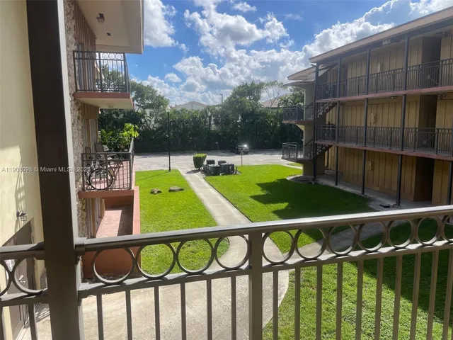 a view of a chairs and table on the balcony