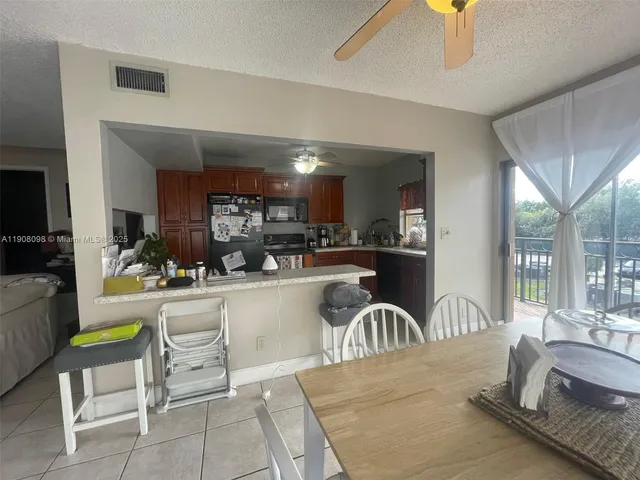 a kitchen with a table chairs and microwave