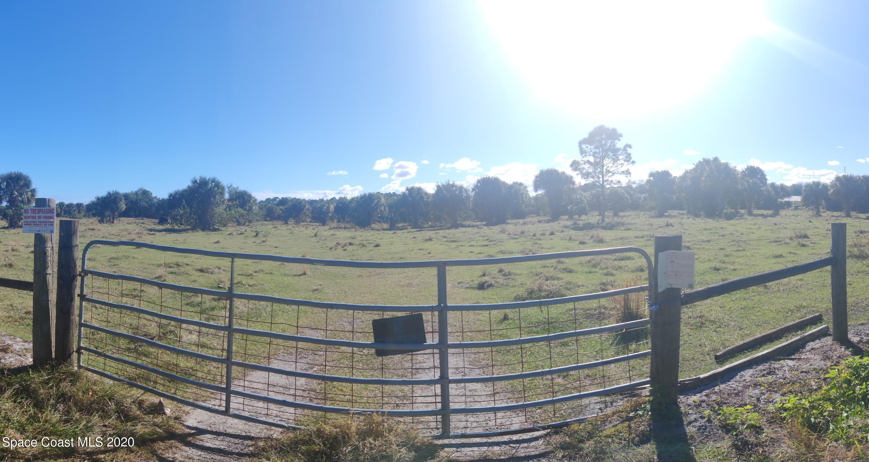 0 Malabar Road Malabar, FL 32950 - Photo 5 of 5 a view of a wooden fence with a view of mountains