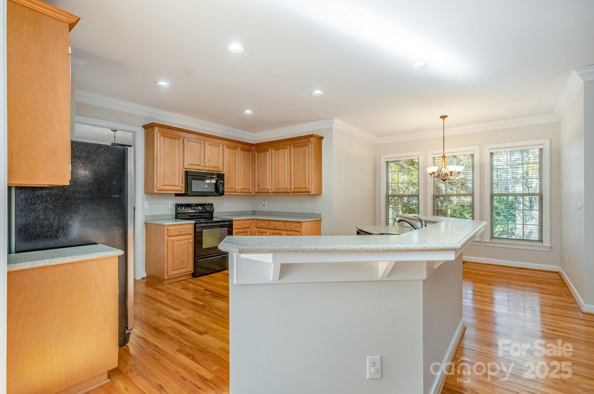 1930 Copperplate Road Charlotte, NC 28262 - Photo 13 of 43 a kitchen with stainless steel appliances kitchen island granite countertop a refrigerator a stove top oven a sink with island and chairs