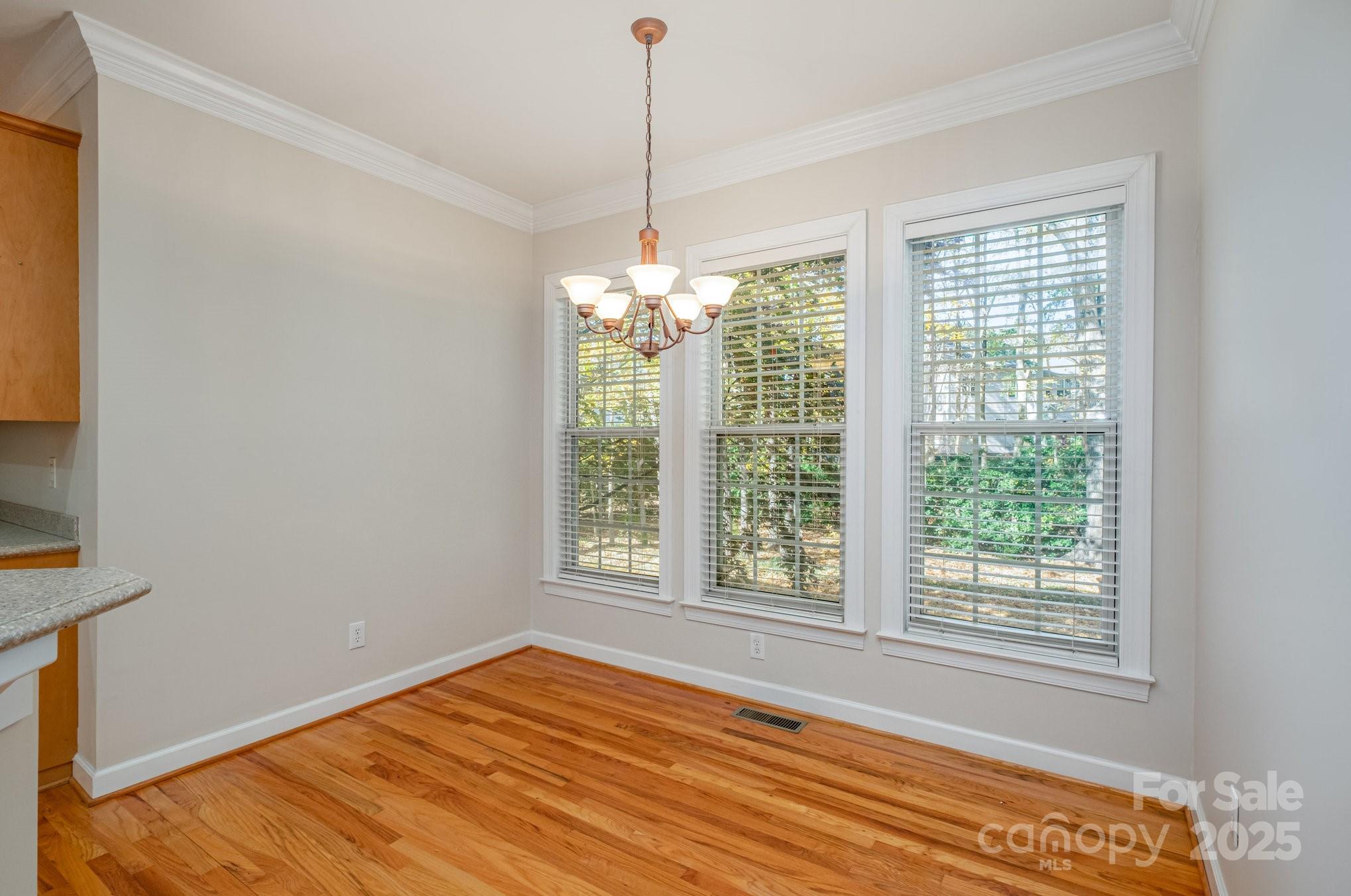 1930 Copperplate Road Charlotte, NC 28262 - Photo 14 of 43 a view of an empty room with wooden floor and a window