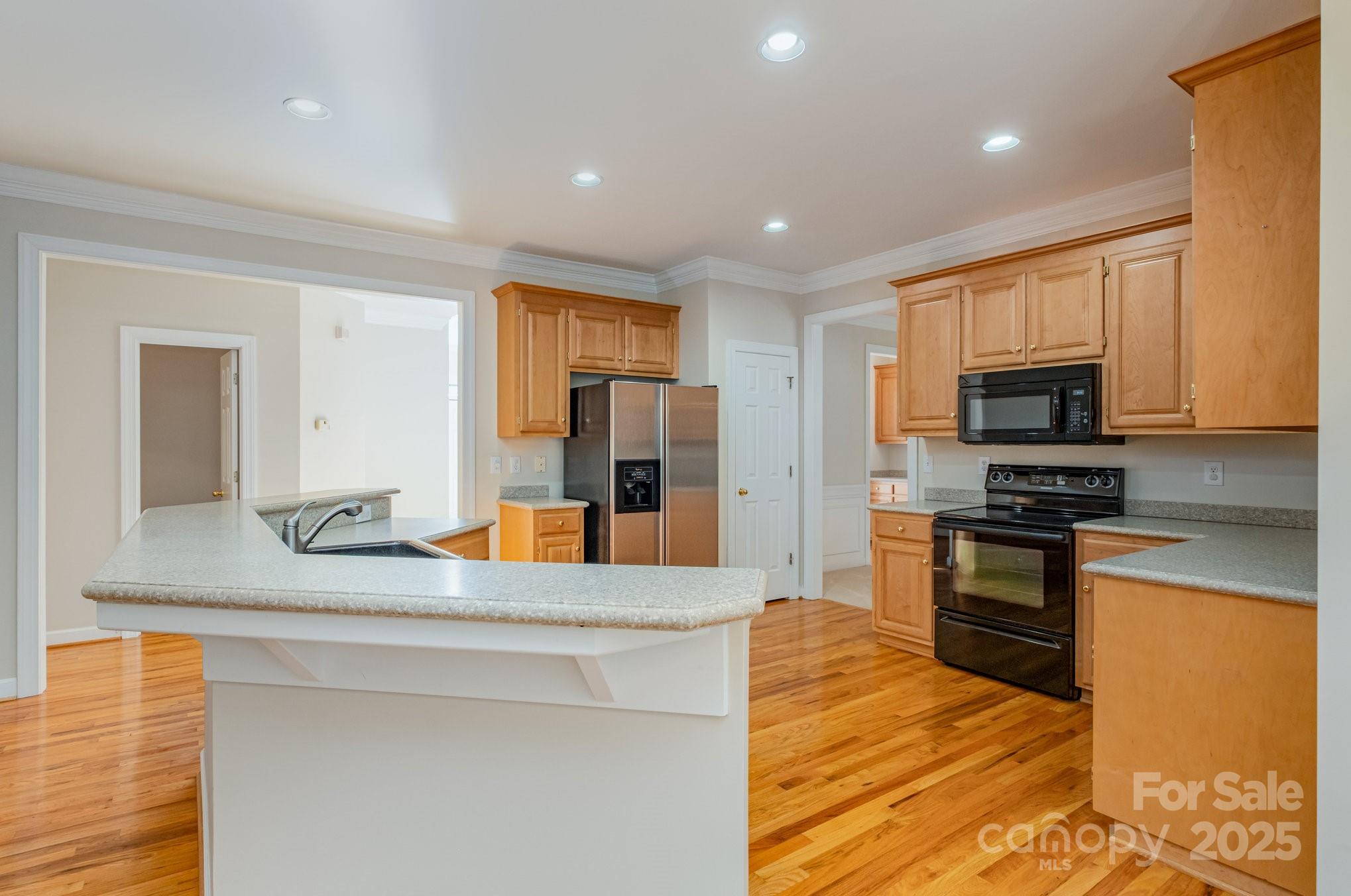 1930 Copperplate Road Charlotte, NC 28262 - Photo 16 of 43 a kitchen with stainless steel appliances granite countertop a sink and microwave
