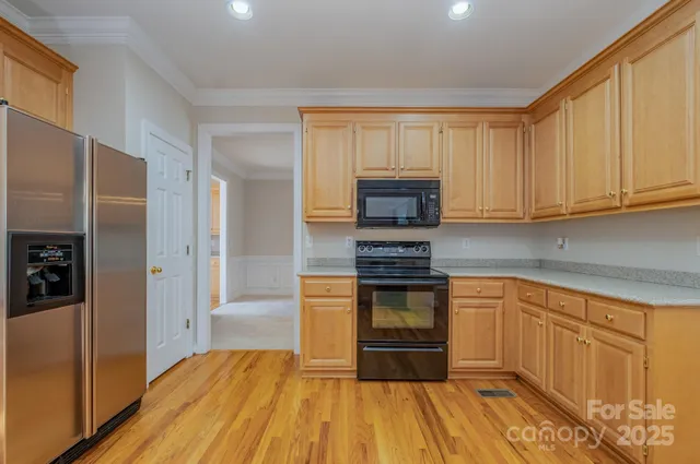 a kitchen with stainless steel appliances a stove a microwave and a refrigerator