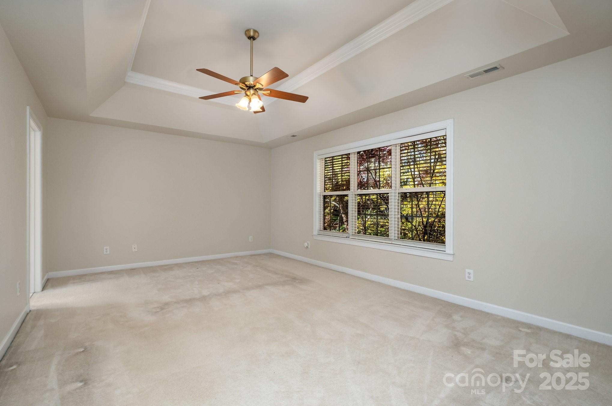 1930 Copperplate Road Charlotte, NC 28262 - Photo 23 of 43 an empty room with a window and a fan