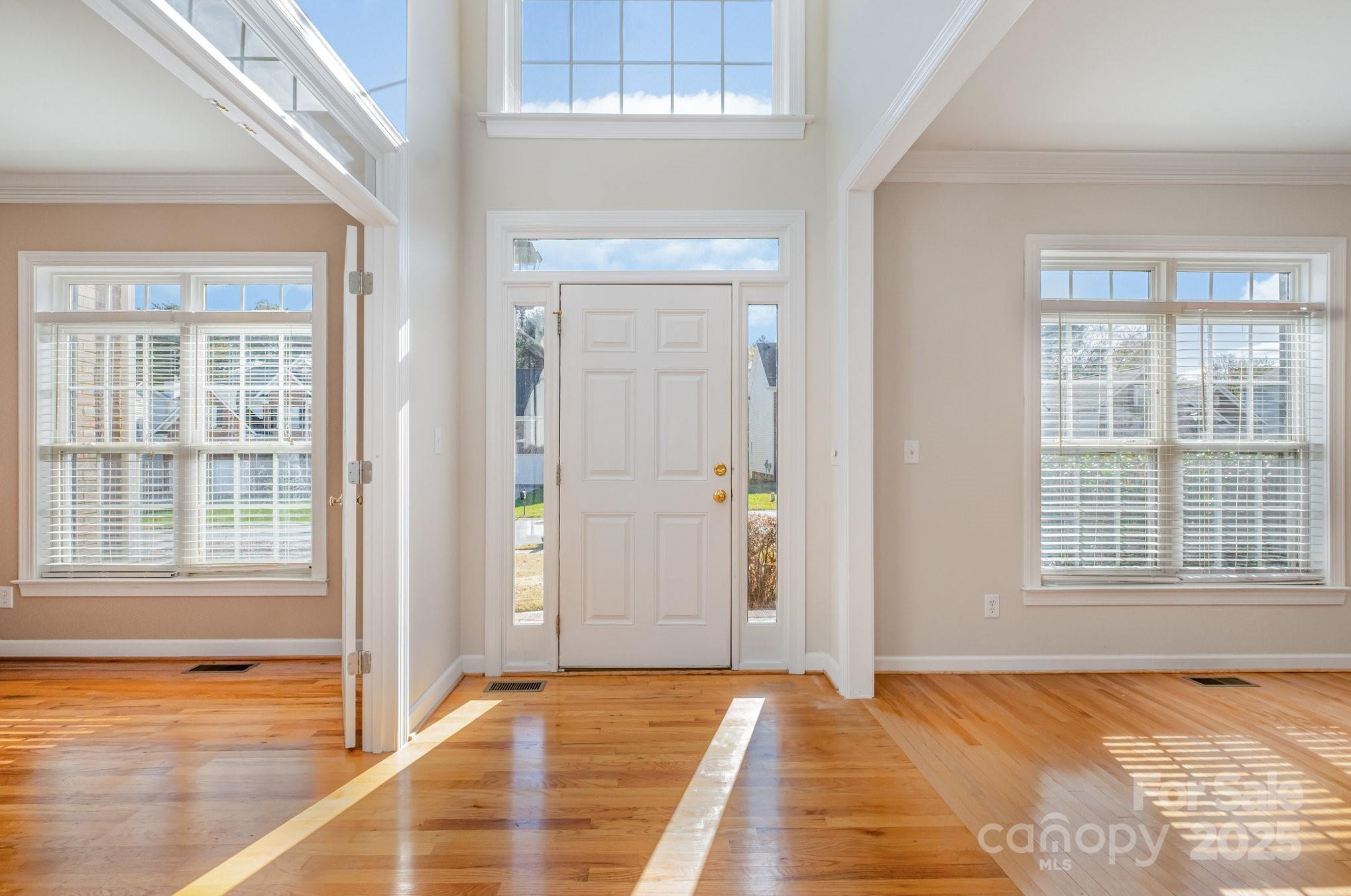 1930 Copperplate Road Charlotte, NC 28262 - Photo 3 of 43 a view of a livingroom with an empty space wooden floor and windows