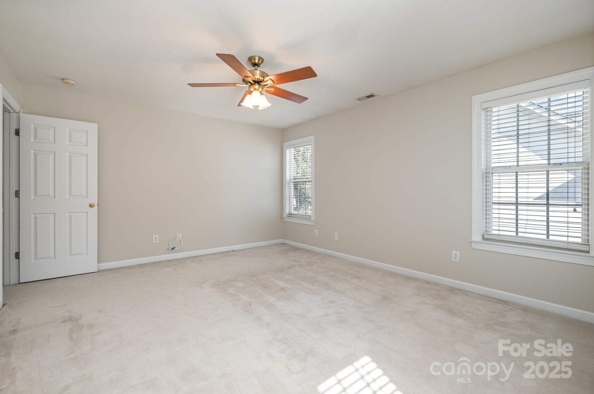 1930 Copperplate Road Charlotte, NC 28262 - Photo 33 of 43 an empty room with windows and fan