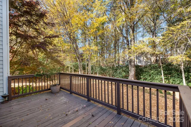 a view of balcony with wooden floor and fence