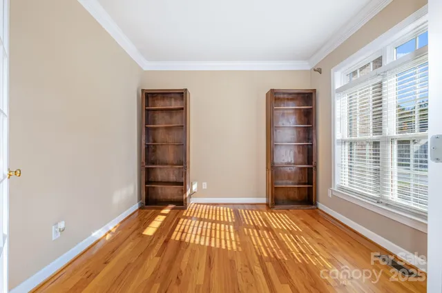 a view of empty room with a door and wooden floor