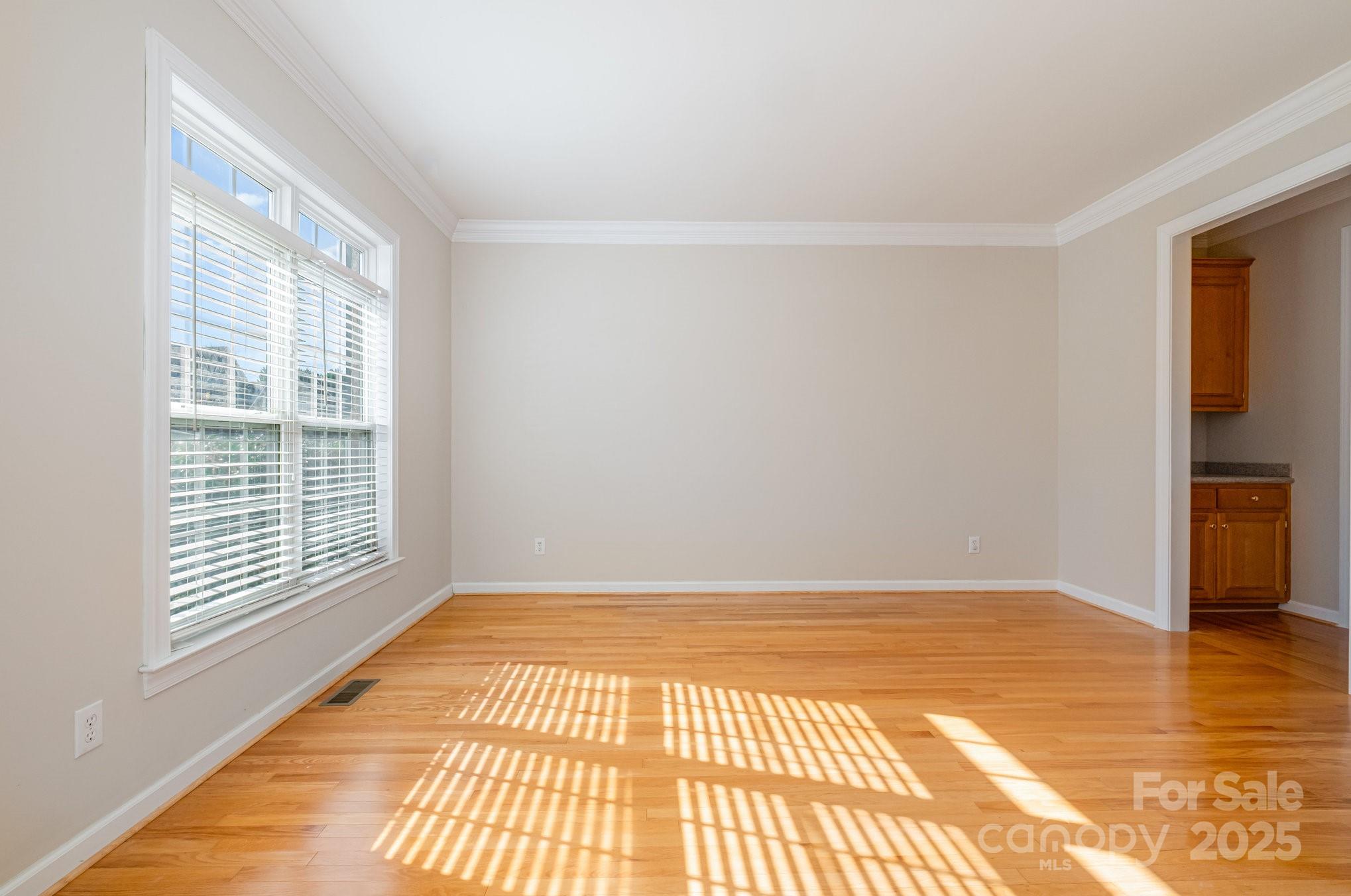 1930 Copperplate Road Charlotte, NC 28262 - Photo 6 of 43 a view of an empty room with wooden floor and a window
