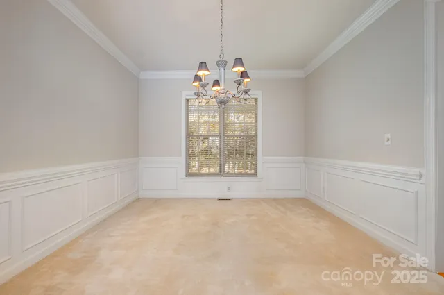 a big room with chandelier and windows