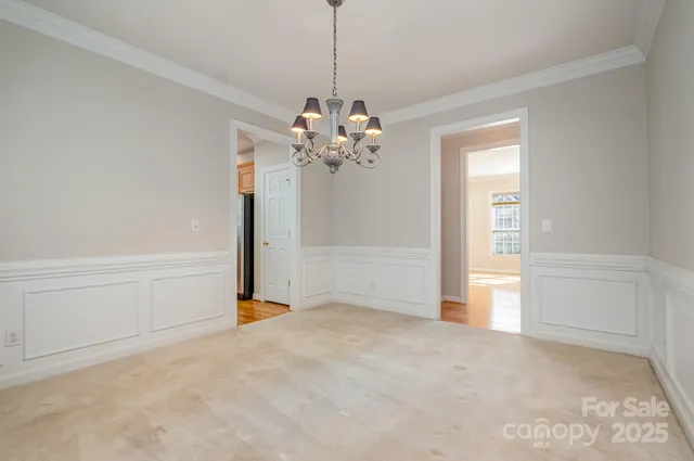 a view of a chandelier in big room and chandelier fan