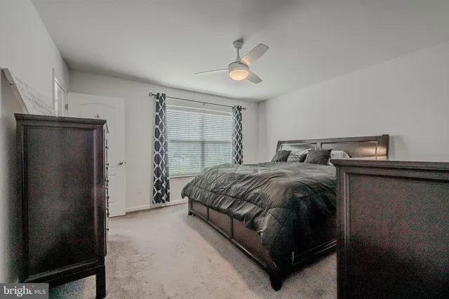 a spacious bedroom with a bed and a window