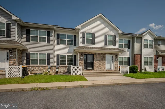 a front view of a house with a yard in front of it