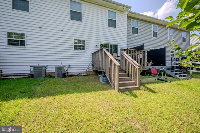 a view of a house with a yard and furniture