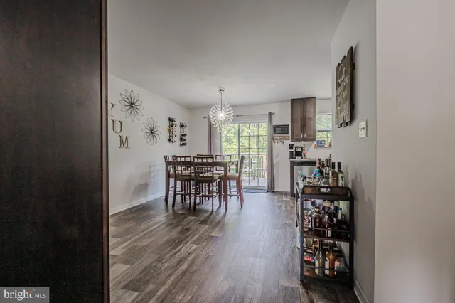 a dining room with furniture and wooden floor