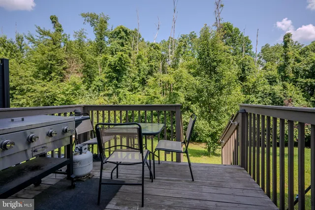 a balcony with table and chairs