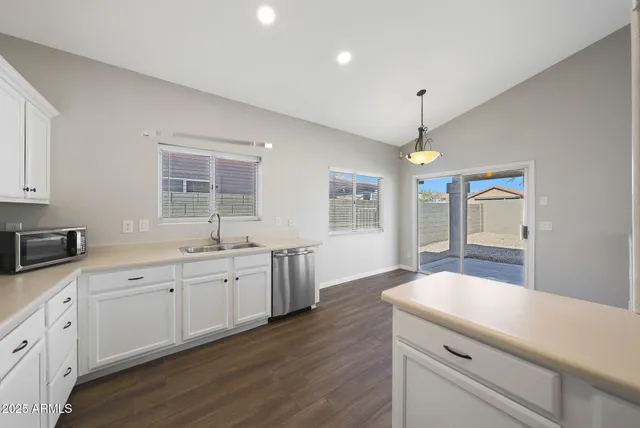 a spacious bathroom with double sink and a large mirror