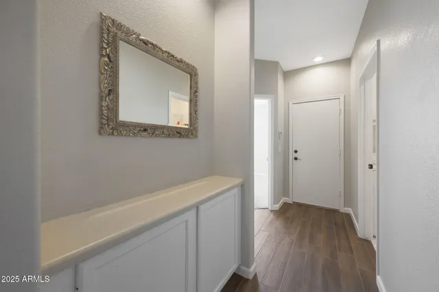 a view of a hallway with wooden floor