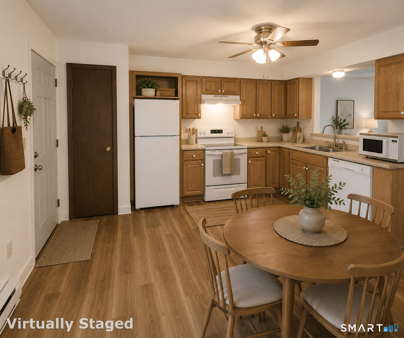975 Meriden Road, Unit 101 Waterbury, CT 06705 - Photo 17 of 28 a kitchen with a table chairs refrigerator and microwave