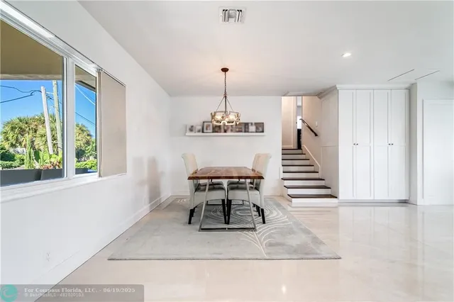 a spacious bedroom with a bed a couch and a window