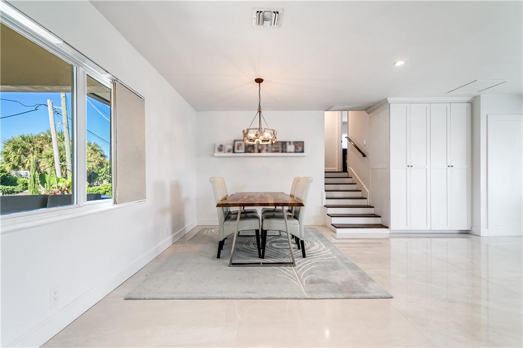 2948 Northeast 35th Court Lighthouse Point, FL 33064 - Photo 13 of 24 a dining room with table and chairs