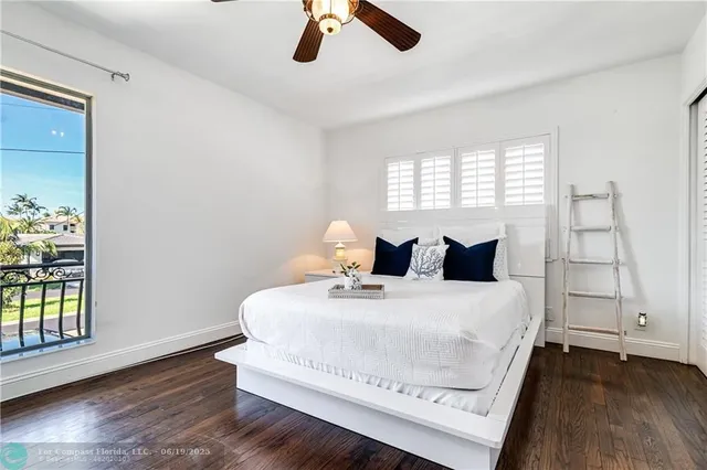 a bedroom with a large bed and a large window