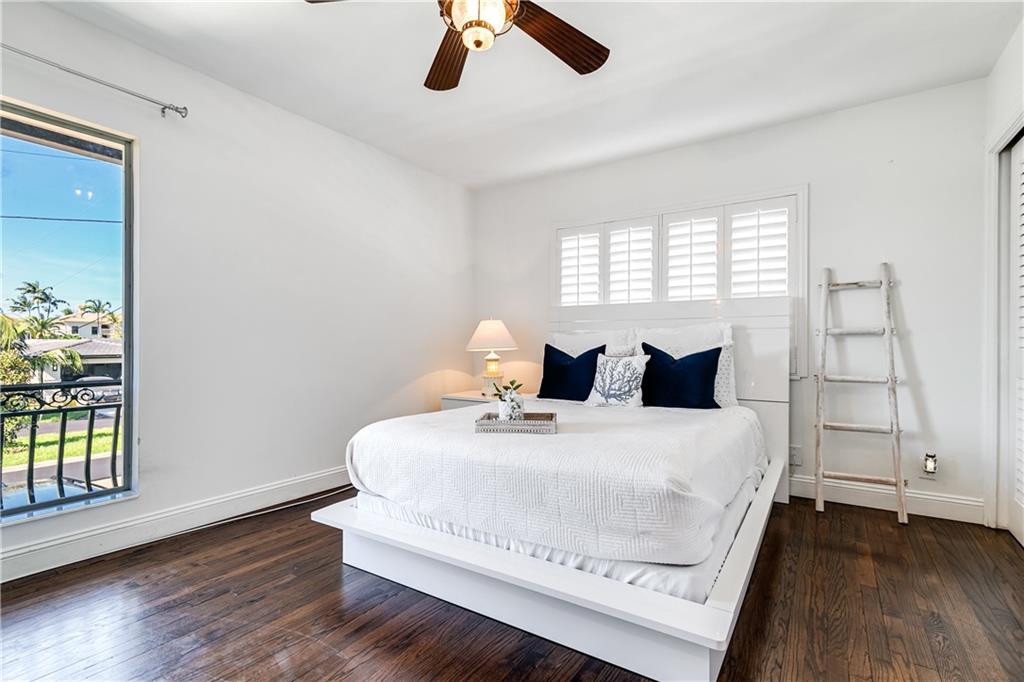 2948 Northeast 35th Court Lighthouse Point, FL 33064 - Photo 15 of 24 a bedroom with a bed and wooden floor