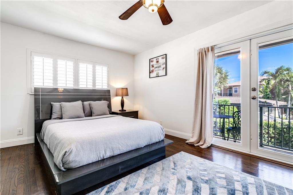 2948 Northeast 35th Court Lighthouse Point, FL 33064 - Photo 16 of 24 a bedroom with a large bed and a large window