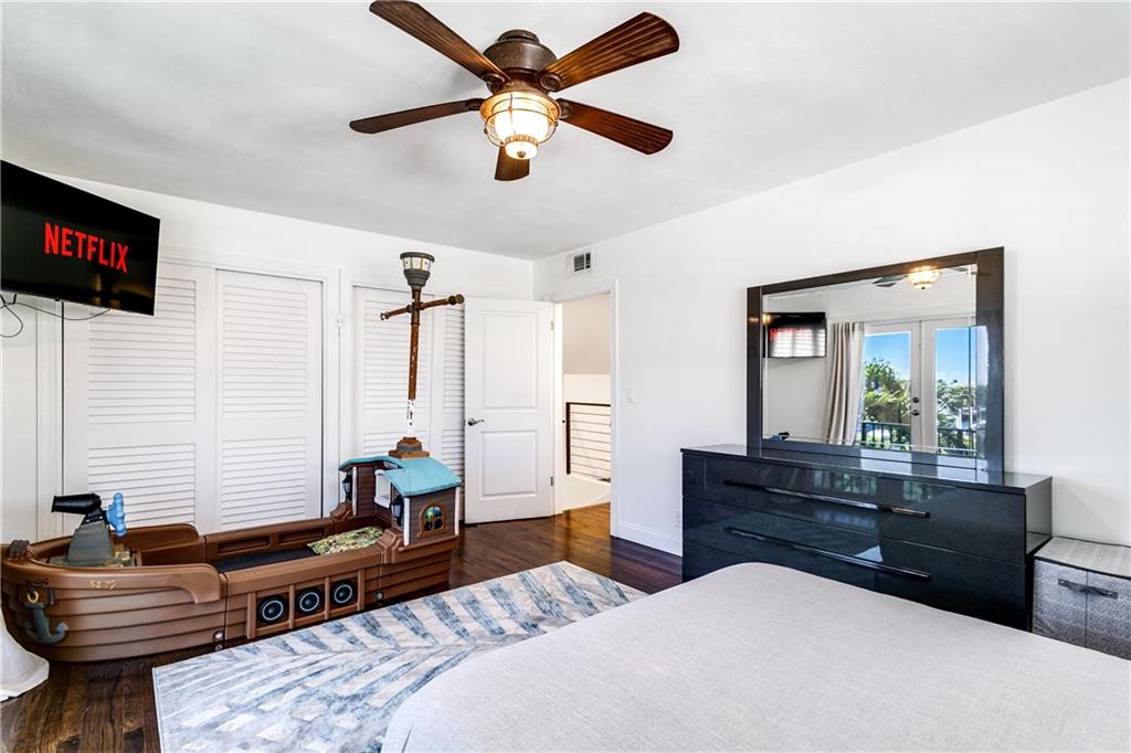 2948 Northeast 35th Court Lighthouse Point, FL 33064 - Photo 17 of 24 a bedroom with a bed and wooden floor