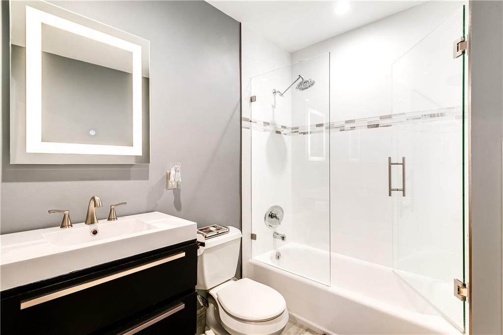 2948 Northeast 35th Court Lighthouse Point, FL 33064 - Photo 18 of 24 a bathroom with a sink vanity mirror and toilet